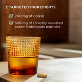 An amber textured glass tumbler sits on a tabletop with a capsule beside it, under the text '2 TARGETED INGREDIENTS:' listing CoQ10 and casein hydrolysate peptides.