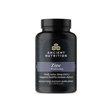Black supplement bottle labeled 'Ancient Nutrition Zinc + Probiotics' on a white background