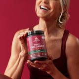 Woman holding a container of Ancient Nutrition Multi Collagen Advanced supplement against a red background