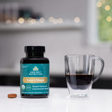 Lion's Mane capsules next to a glass of coffee