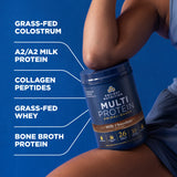 Person holding a protein supplement container with text listing ingredients on a blue background