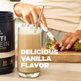 Glass of vanilla-flavored protein shake with a container labeled 'Collagen Protein' on a wooden surface.