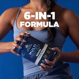 A woman in a light blue tank top holds a tub of Ancient Nutrition Multi Protein Vanilla Bean against a solid blue background, with the text '6-IN-1 FORMULA' overlaid in white.