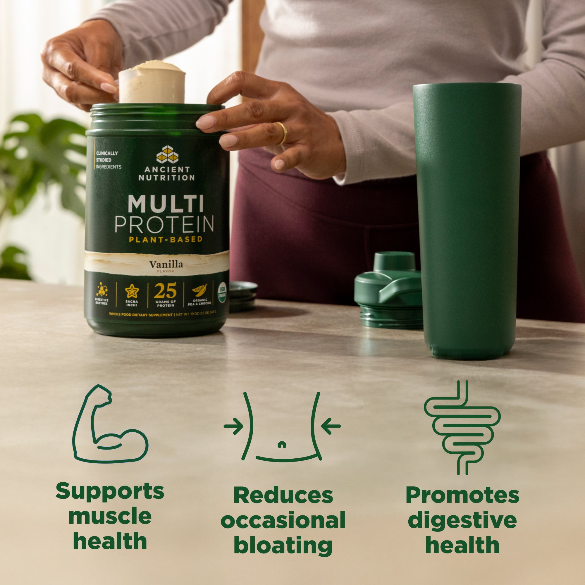 Person holding a container of Ancient Nutrition Multi Protein with health benefits displayed on a table.