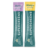 Two Organic Supergreens packets, one berry flavor and one mango flavor, on a white background.