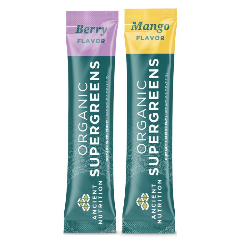 Two Organic Supergreens packets, one berry flavor and one mango flavor, on a white background.