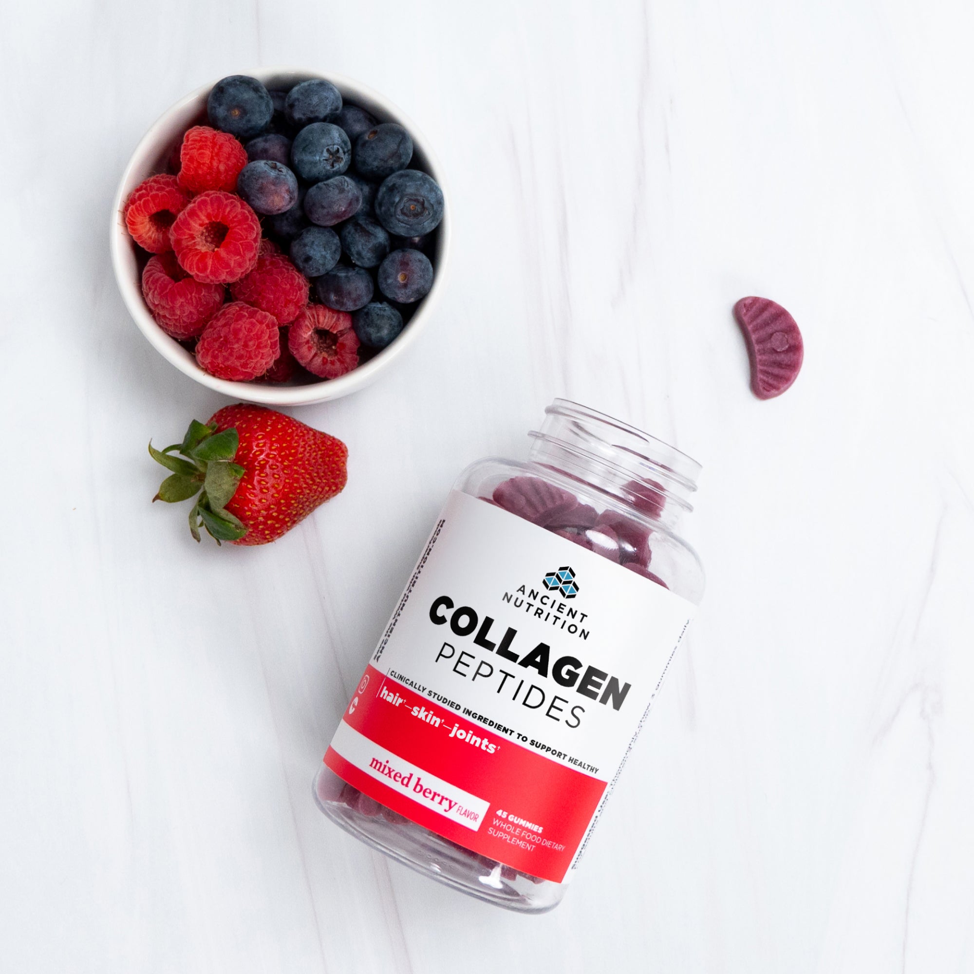 collagen peptides gummies next to a bowl of fruit