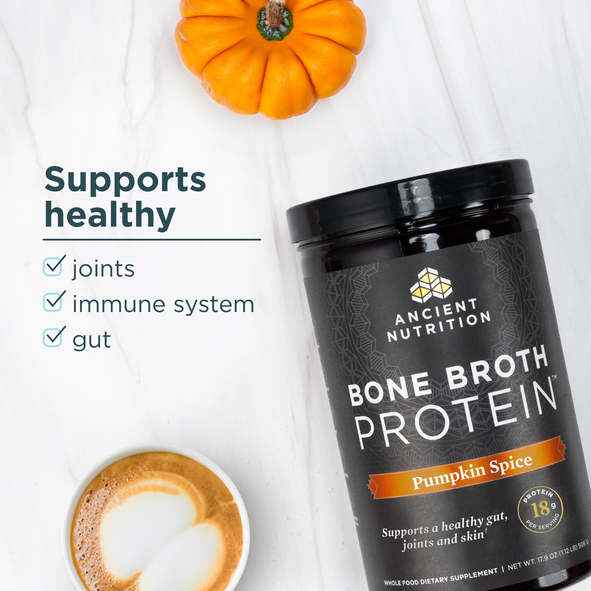 Ancient Nutrition Bone Broth Protein Pumpkin Spice container with a pumpkin and coffee on a white background