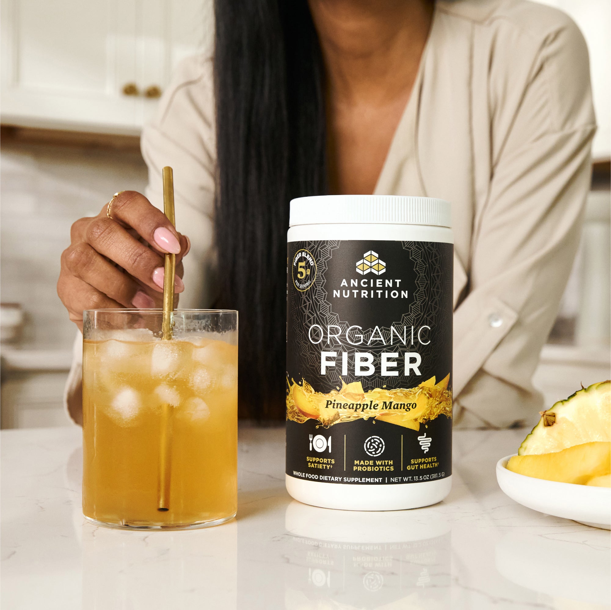 a glass of Organic Fiber Powder Pineapple Mango Flavor (60 Servings)