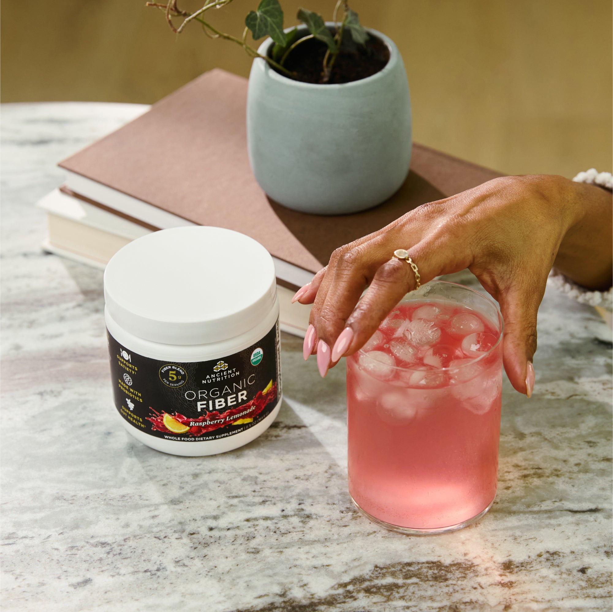 a glass of Organic Fiber Powder Raspberry Lemonade Flavor (30 Servings)