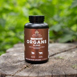 a bottle of Organs Blend Once Daily Tablets  on a tree stump