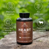 Heart Blend Capsules (30 Servings) Supplement bottle on a wooden surface with greenery in the background.