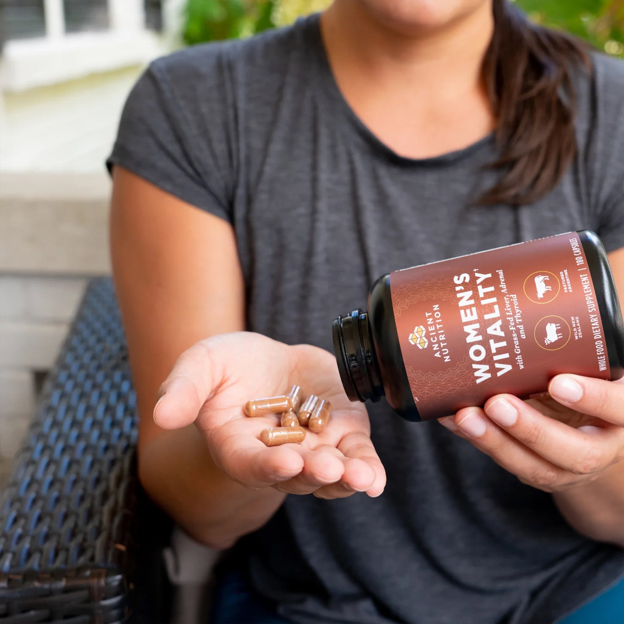 woman with organ blend womens vitality capsules in hand