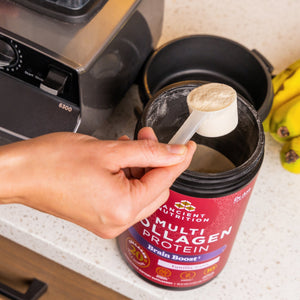 person taking a scoop of Multi collagen brain boost powder 