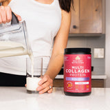 woman pouring smoothie in a glass