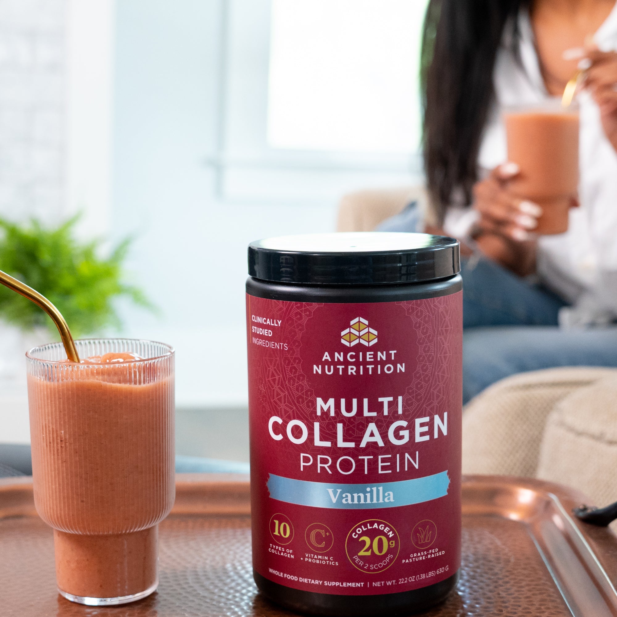 a bottle of Multi Collagen Protein Powder Vanilla (60 Servings) next to a smoothie