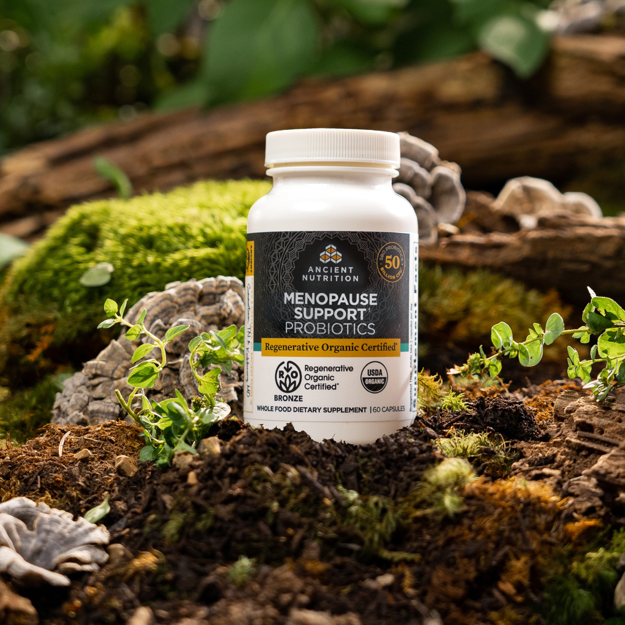 bottle of Regenerative Organic Certified™ Menopause Support Probiotics on a mossy rock