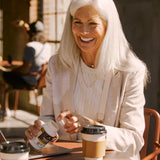 a woman holding a bottle of Regenerative Organic Certified® Metabolism Support Probiotics Capsules (60 Capsules)