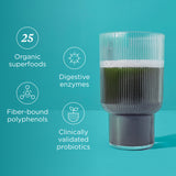 Glass of green juice with health benefits listed on a teal background