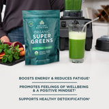 Organic SuperGreens Powder Greens Flavor (50 Servings) next to a blender