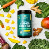 Organic SuperGreens Powder Mango Flavor (25 Servings) surrounded by fruits and vegetables