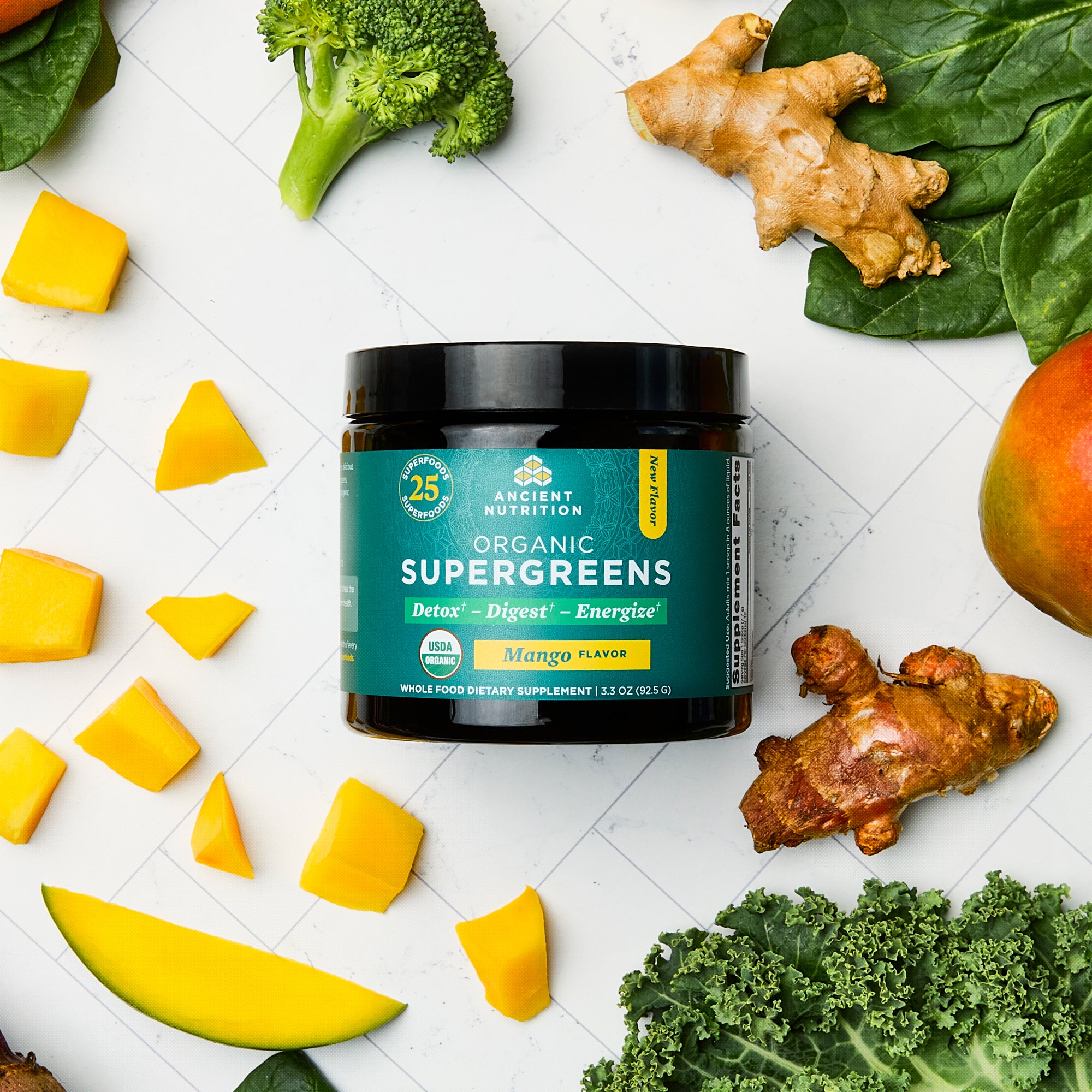 Organic SuperGreens Powder Mango Flavor (12 Servings) surrounded by fruit