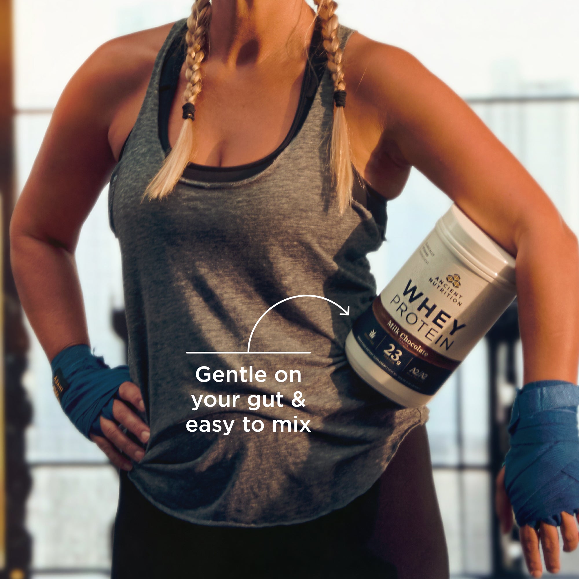 a person in the gym holding a bottle of Whey Protein Powder Chocolate