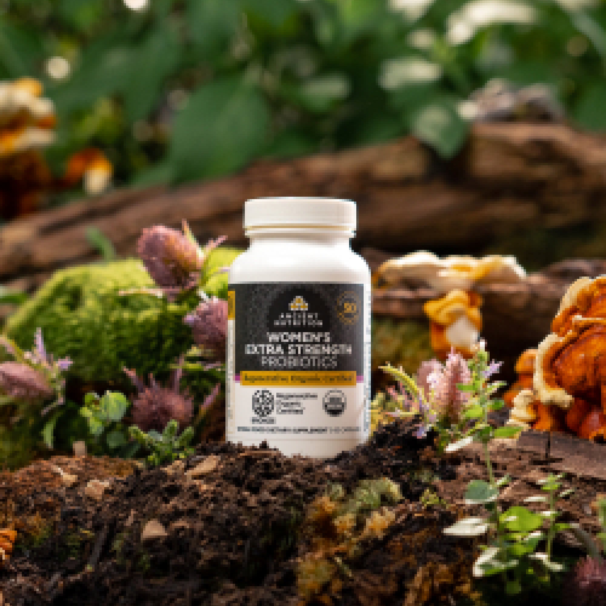 a bottle of Regenerative Organic Certified™ Women's Extra Strength Probiotics on a mossy rock 