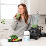 a woman drinking a green smoothie