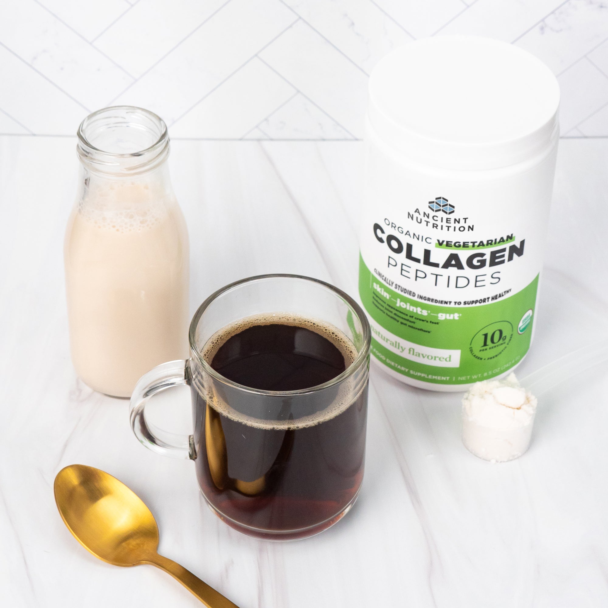 Vegetarian Collagen Peptides Powder (28 Servings) next to a cup of coffee