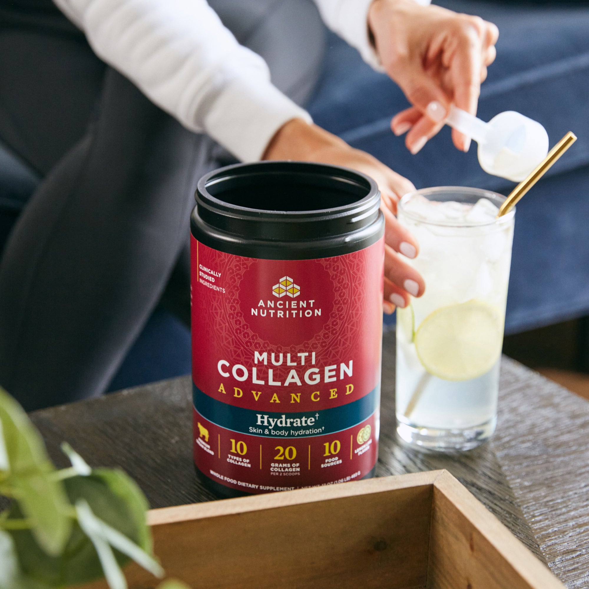 a person scooping Multi Collagen Advanced Hydrate Powder Lemon Lime