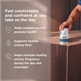 A hand holds a white bottle labeled 'Men's Prostate Support' on a stone ledge, with marketing text on the left about supporting prostate health and urinary flow.