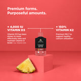 A bottle of Liposomal Vitamin D3 + K2 Gel Packs Pineapple flavor supplement displayed on a pink pedestal against a solid pink background, with a pineapple slice at the base and promotional text overlays.