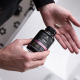 person putting SBO Probiotics Women's Once Daily capsules in their hand