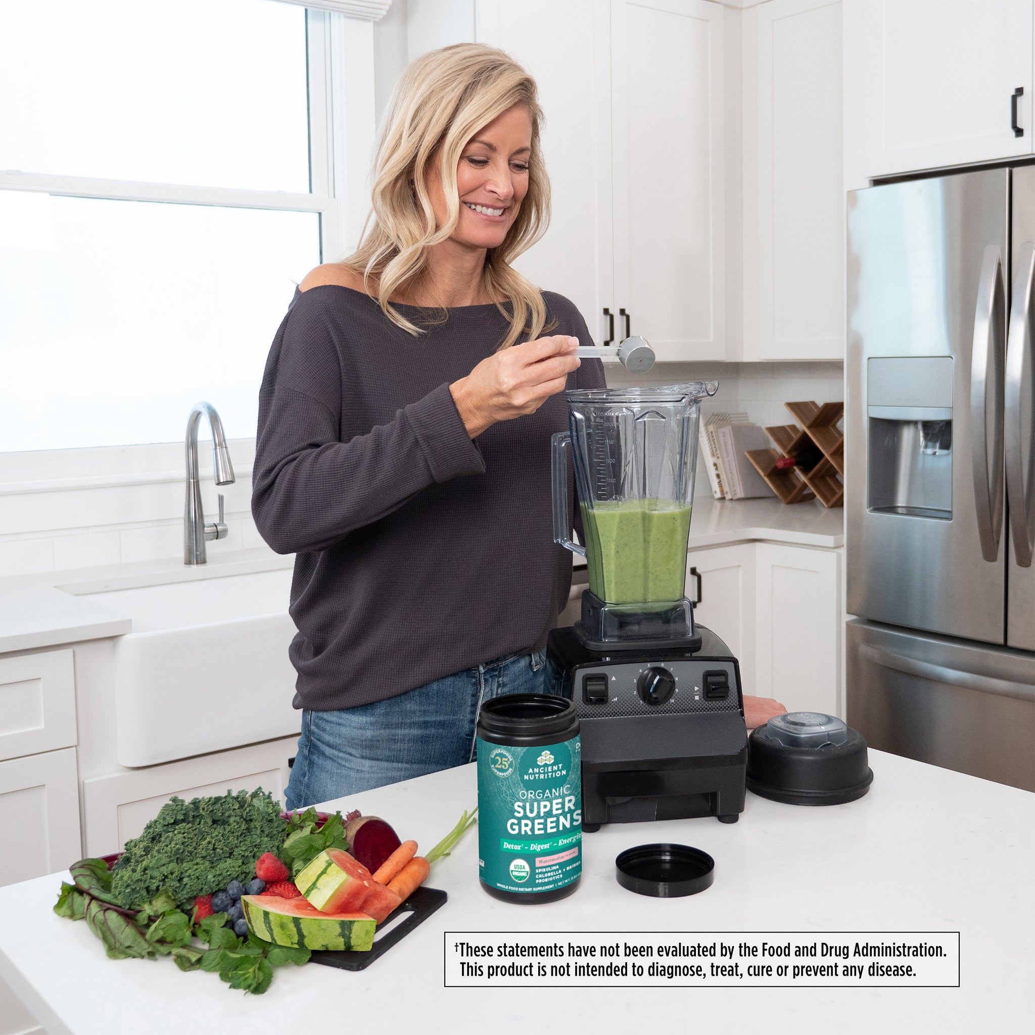 woman scooping. Organic SuperGreens Powder Watermelon into a blender