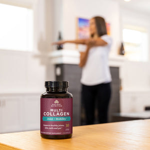 bottle of multi collagen joint + mobility (45 count) on table while woman stretches in the background