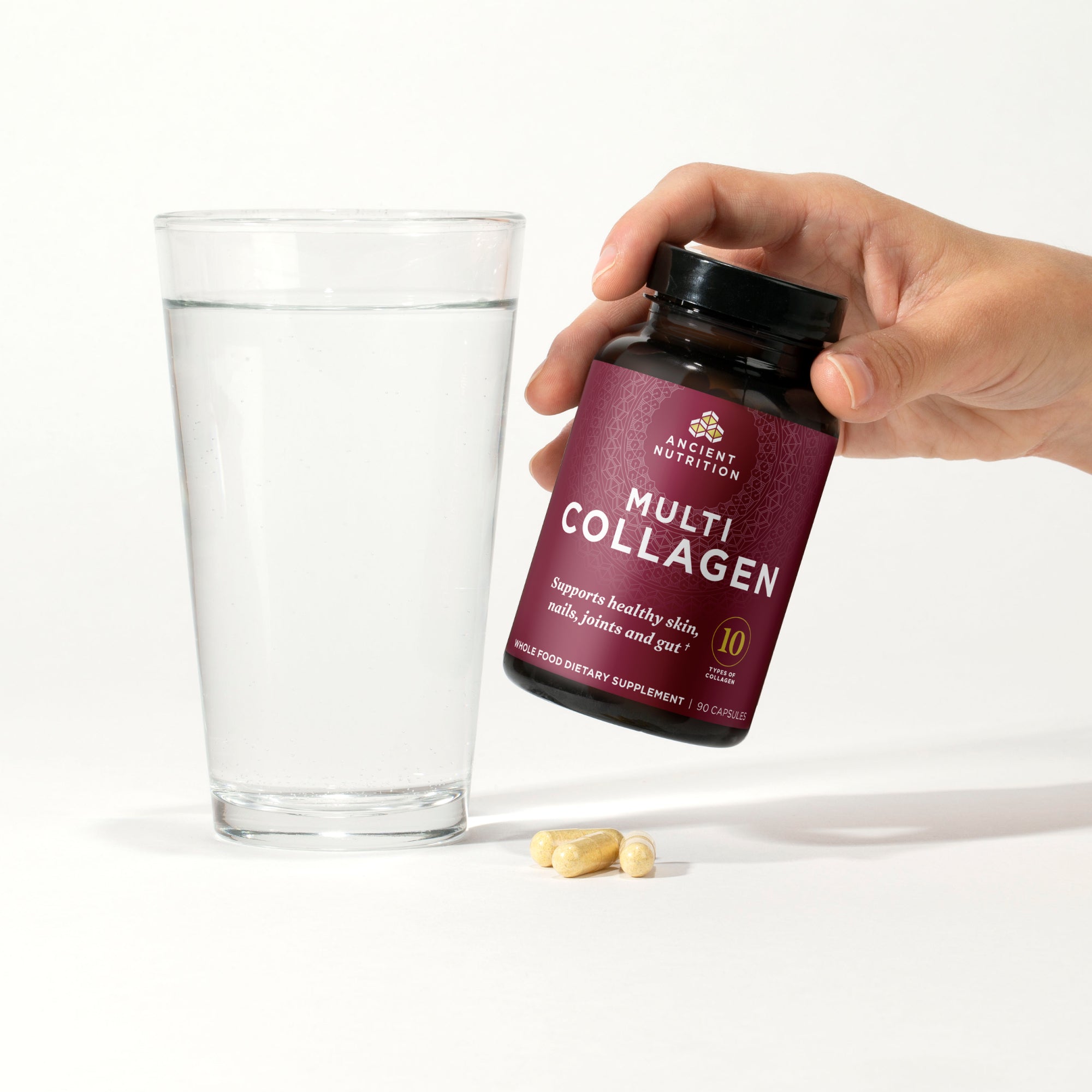 person holding a bottle of multi collagen capsules