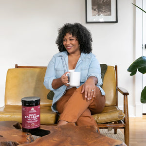 woman sitting on a leather couch with a white coffee mug
