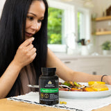 digestive enzymes bottle next to a woman eating