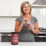woman in kitchen drinking multi collagen protein beauty within 