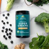 Organic Super Greens + Organic Collagen Powder surrounded by fruits and veggies